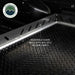 Image of Overland Vehicle Systems truck bed extension with diamond plate surface, showing removable guard rails with multiple anchor points, close-up view of the rail system