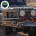 Image of off-road vehicle front bumper equipped with Overland Vehicle Systems kinetic recovery rope and winch, black braided rope with red reinforced loops mounted on rugged off-road truck in outdoor terrain.