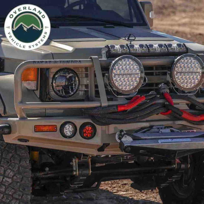 Image of off-road vehicle front bumper equipped with Overland Vehicle Systems kinetic recovery rope and winch, black braided rope with red reinforced loops mounted on rugged off-road truck in outdoor terrain.