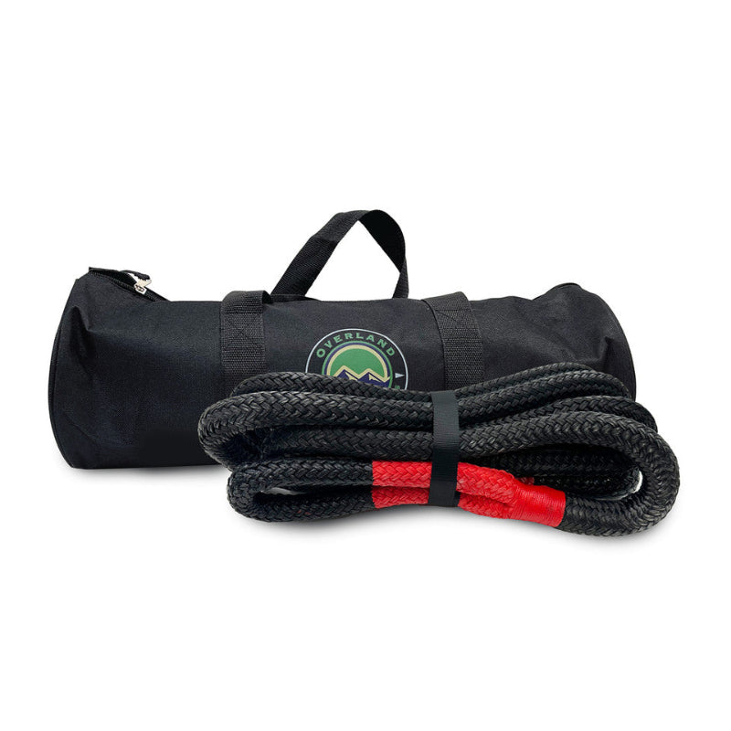 Image of Overland Vehicle Systems kinetic recovery rope coiled with red reinforced loop and black braided synthetic rope, paired with branded black storage bag with carry handles, front view on white background.