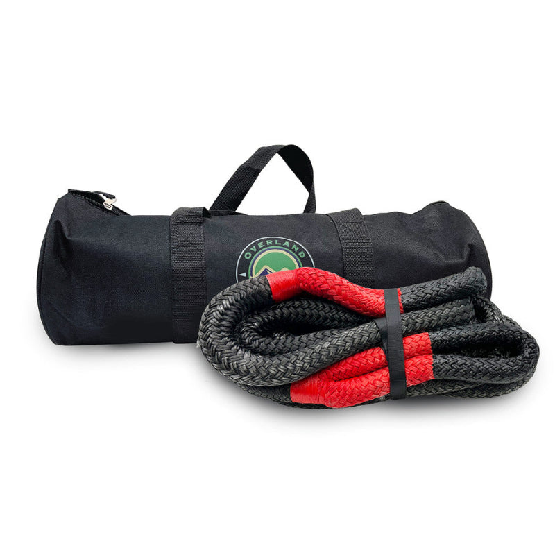 Image of Overland Vehicle Systems kinetic recovery rope with red reinforced loops and black braided synthetic rope, displayed with branded black storage bag, angled front view on white background.