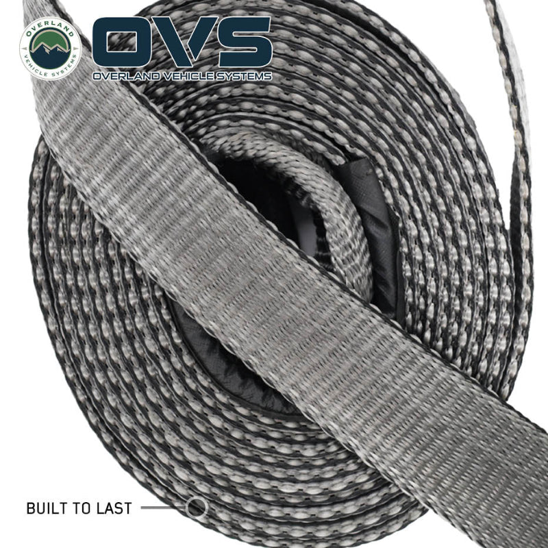 Image of OVS Brute Recovery Tow Strap tightly coiled, showing durable gray synthetic webbing with reinforced construction, angled top view on a white background.