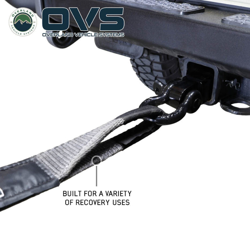 Image of OVS Brute Recovery Tow Strap in use, showing the gray reinforced loop attached to a vehicle recovery shackle, close-up angled view on a white background.