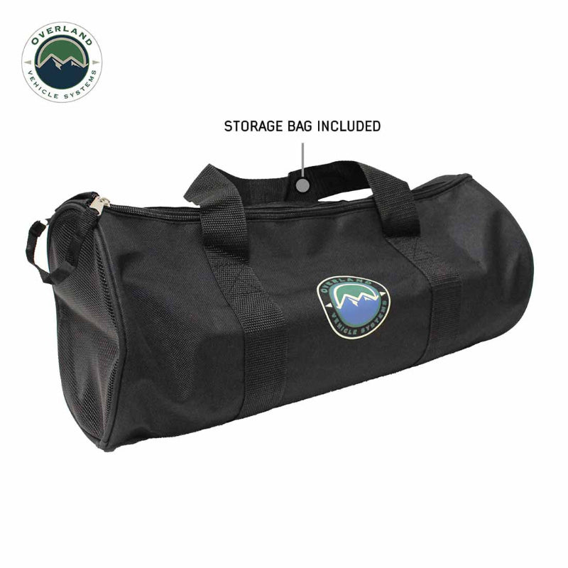 Image of heavy-duty black storage bag with carry handles and Overland Vehicle Systems logo, cylindrical soft case for recovery gear, angled front and side view on white background.