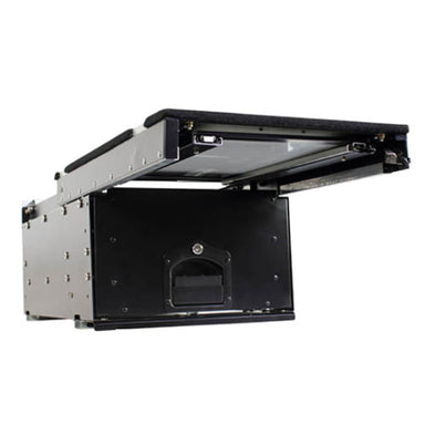 Image of an OVS Cargo Box, a black and silver metal storage drawer system for vehicles. The top of the cargo box is open, revealing the empty interior and a sliding tray on the top