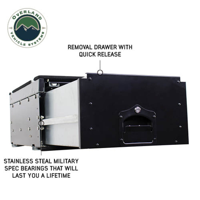 Image of an OVS Cargo Box with its main drawer fully extended to show the quick-release and stainless steel military-spec bearings. The black and silver storage drawer system for vehicles is shown from a side view with descriptive text