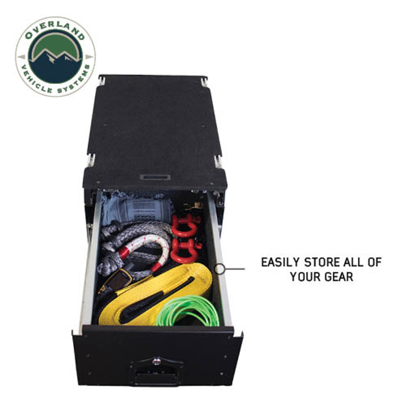 Image of an Overland Vehicle Systems (OVS) Cargo Box with one drawer fully extended, filled with various recovery gear including tow straps, shackles, and a winch line. This demonstrates the ample storage space and organization capabilities of the drawer system