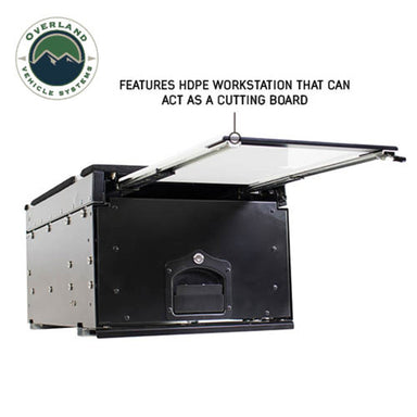 Image of an OVS Cargo Box with its HDPE workstation extended and open, suggesting its use as a cutting board. The black and silver metal storage drawer system for vehicles is shown on a white background with text highlighting this feature