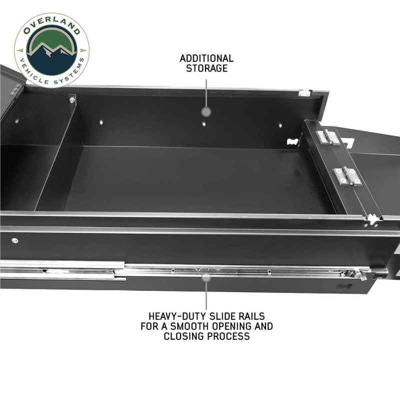 Image of an Overland Vehicle Systems (OVS) Cargo Box Cooking Station, fully extended to show the internal compartments, with text callouts for "HEAVY-DUTY SLIDE RAILS" and "ADDITIONAL STORAGE." The box is black, viewed from a close-up, angled perspective on a white background