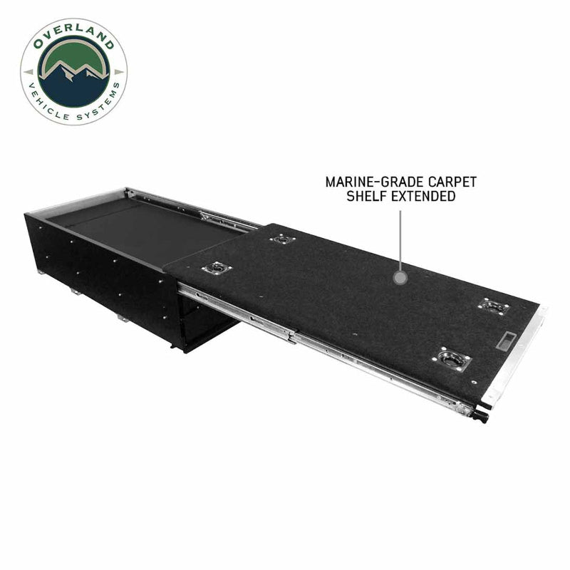 Image of a black Overland Vehicle Systems (OVS) Cargo Box with a single drawer extended, showing the "MARINE-GRADE CARPET SHELF EXTENDED" and an OVS logo in the top left corner, all on a white background