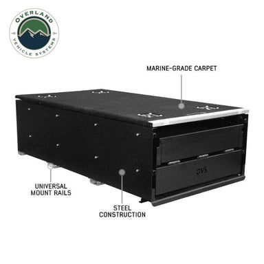 Image of a black Overland Vehicle Systems (OVS) Cargo Box with two drawers, labeled with "MARINE-GRADE CARPET," "UNIVERSAL MOUNT RAILS," and "STEEL CONSTRUCTION." The OVS logo is visible in the top left corner, all on a white background