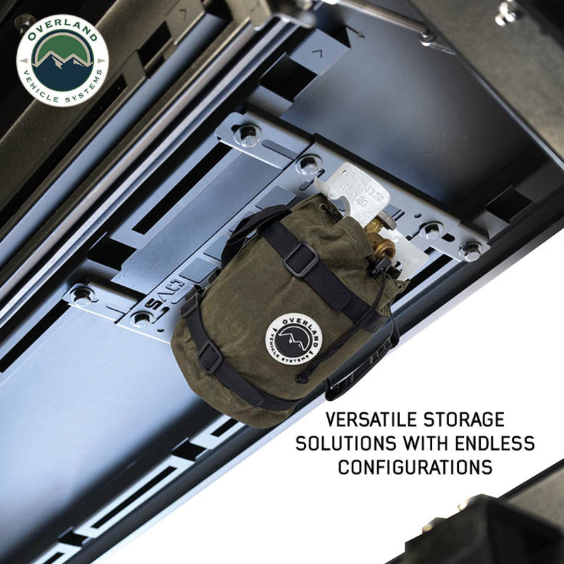 Image of a MOLLE panel installed on the ceiling of a vehicle, holding a propane tank secured in an Overland Vehicle Systems bag. The image is a close-up angled shot from below, showcasing a unique and versatile storage solution