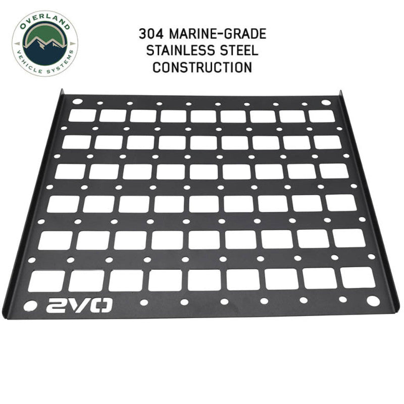 Image of a black MOLLE panel made from 304 marine-grade stainless steel, featuring a grid of square cutouts and circular mounting points. The panel is shown at a slight angle on a white background, with the OVS logo on the bottom