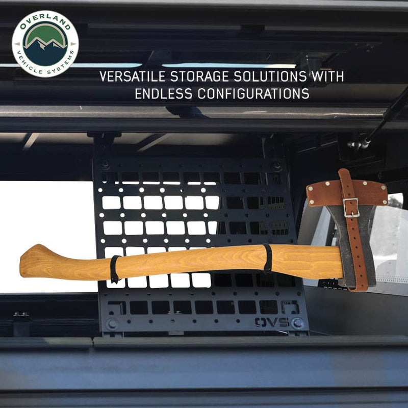 Image of a square black MOLLE panel installed on the ceiling of a vehicle, holding a hatchet and demonstrating a practical, versatile storage solution. The panel is mounted with the included hardware, showing how tools can be securely stowed within the vehicle's interior