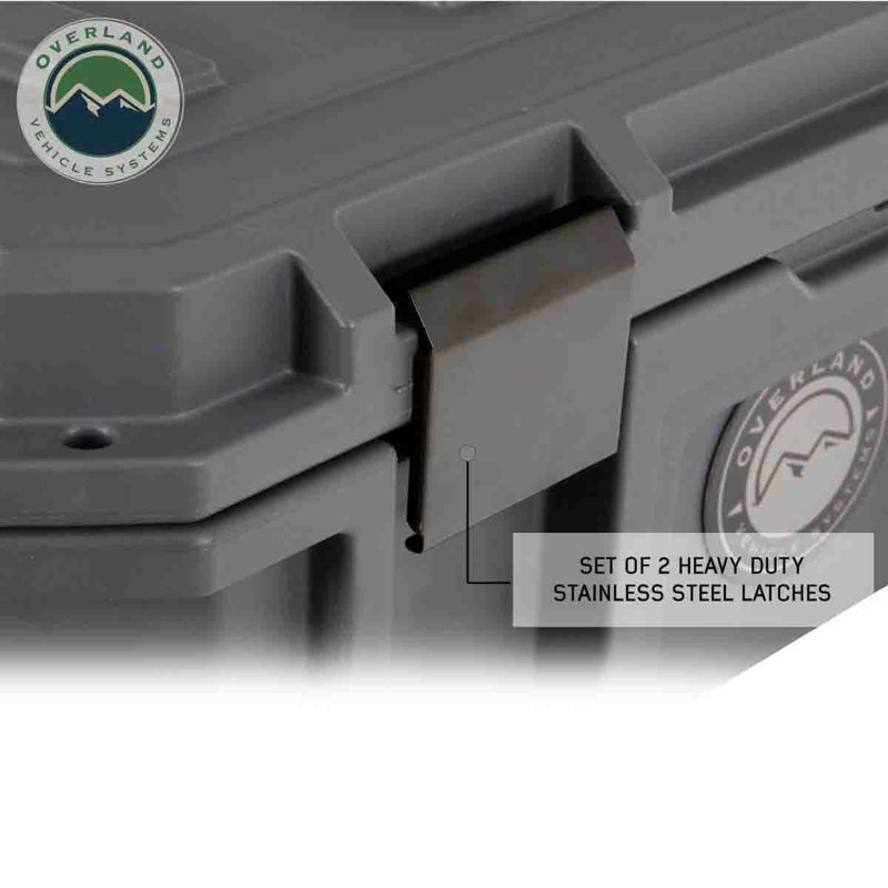 Image of hard-shell storage dry box latch detail with heavy-duty stainless steel locking latch, dark gray rugged plastic construction shown in close-up angled view on white background.