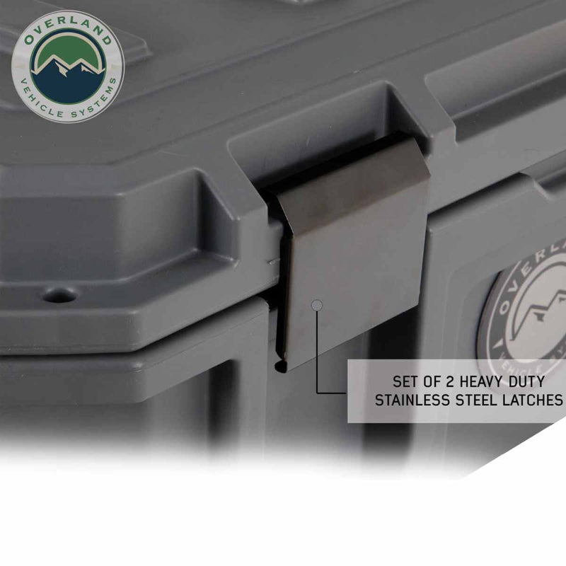 Image of dry box stainless steel latch detail showing heavy-duty locking hardware on dark gray storage box, close-up angled side view on white background.