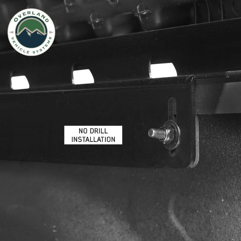 Image of Overland Vehicle Systems roof rack close-up showing no drill installation with a visible mounting bolt, with a text overlay emphasizing "No Drill Installation" on a black background