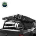 Image of Overland Vehicle Systems roof rack mounted on a truck with rooftop tent and mounted recovery ramps, side view with black fabric awning and visible storage options, on a white background