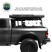Image of Overland Vehicle Systems roof rack mounted on a truck with MOLLE-PAL mounting plates holding Roto Pax fuel cans and recovery ramps, side view with a text overlay highlighting the mounting plate features