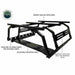 Image of the black OVS Discovery Rack, highlighting its square tubular crossbars, adjustable mounting shelf, truck bed tie-down points, and mounting plates with MOLLE-PAL mounting holes, shown on a white background