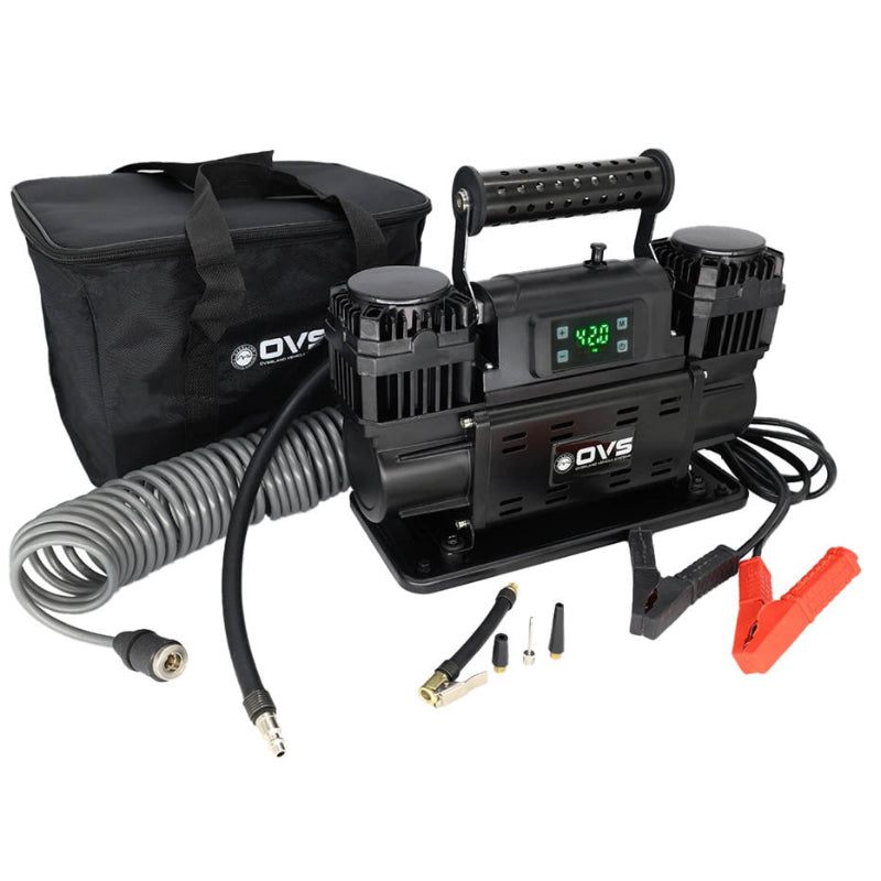 Image of OVS portable digital air compressor kit with dual motors, carry handle, digital display, air hose, clamps, accessories, and storage bag, angled front view on white background.