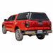 Image of a bright red Ford Ranger truck with a black truck bed cap installed. The cap has a rear window and side access doors, shown from a rear three-quarter view on a white background