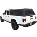 Image of a white Jeep Gladiator pickup truck with a black soft shell camper top, angled rear and side view on a white background. The soft top is made of durable black fabric with a frame