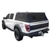 Image of a white Ford Raptor pickup truck with a black soft shell camper top, angled rear and side view on a white background. The soft top is made of a durable black canvas with an aluminum frame