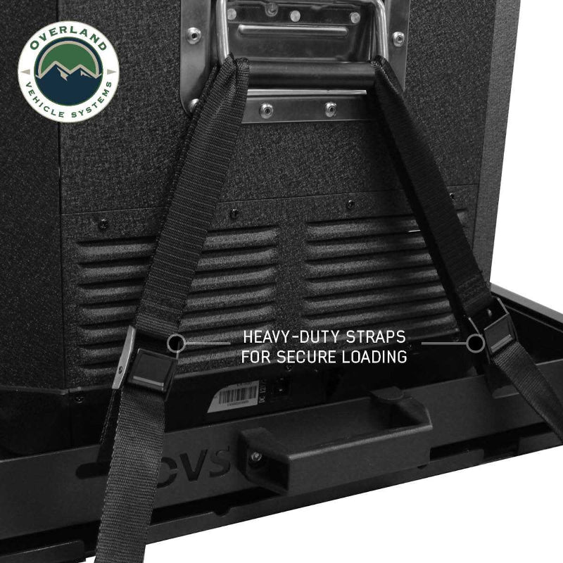 Image of a portable refrigerator secured to an OVS slide with heavy-duty straps, shown in a close-up view with text "HEAVY-DUTY STRAPS FOR SECURE LOADING". This image highlights the robust strapping system designed to keep a refrigerator firmly in place during travel, ensuring stability and safety
