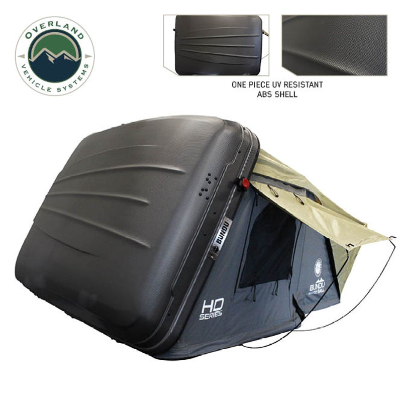 Image of Bundu HD Series roof top tent with UV-resistant ABS shell, black finish, partially deployed with beige fabric canopy, side view with angled roof, showing exterior shell and tent structure