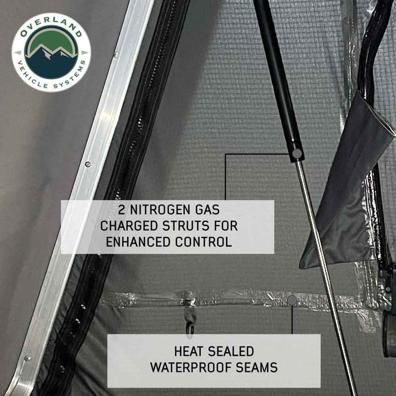 An image showing a close-up of the Bushveld Hard Shell Roof Top Tent's interior, highlighting "2 NITROGEN GAS CHARGED STRUTS FOR ENHANCED CONTROL" and "HEAT SEALED WATERPROOF SEAMS" on the grey fabric
