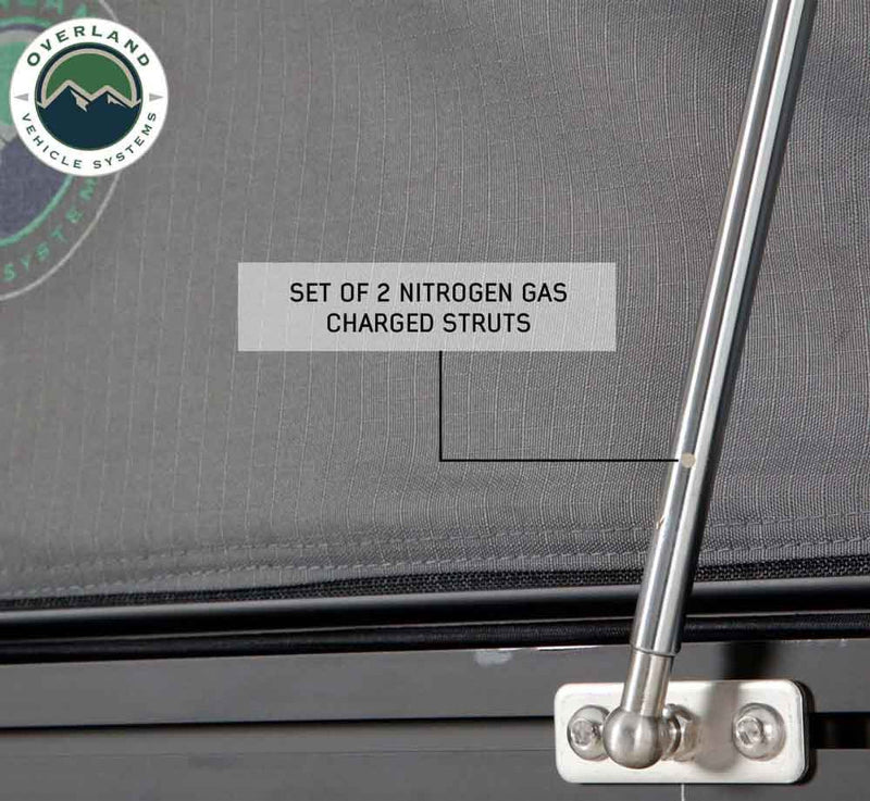 Image of Mamba Clam Shell Roof Top Tent showing a set of 2 nitrogen gas-charged struts with close-up view of the metal fittings, on a grey fabric background