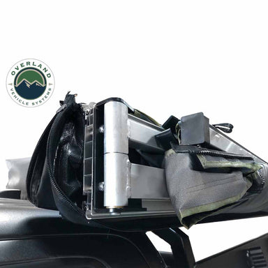 Image of the OVS Nomadic Awning showing a close-up of the reinforced oversized hinges and heavy-duty rafters. The awning is partially unzipped from its travel cover, revealing its internal structure
