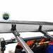 Image of the OVS Nomadic Awning mounted to a vehicle's roof rack, showing a close-up of the heavy-duty mounting brackets and hardware