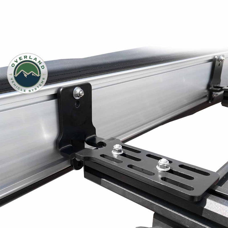 Image of the OVS Nomadic Awning showing a close-up of a single heavy-duty mounting bracket securing the awning to a vehicle's roof rack