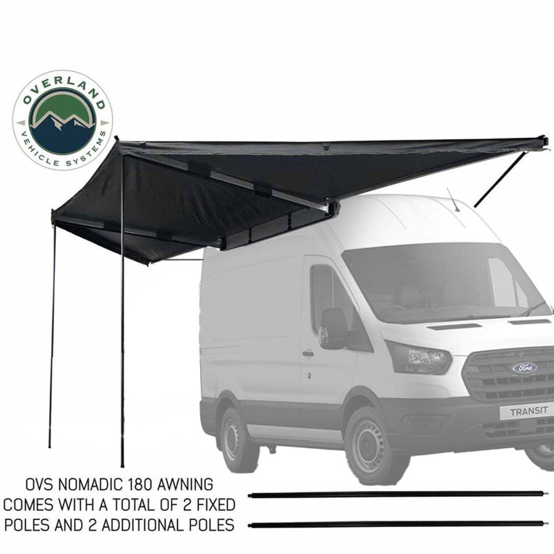 Image of the OVS Nomadic 180 Awning fully deployed on a white Ford van, supported by poles. The awning is black on both sides, angled front and side view on a white background