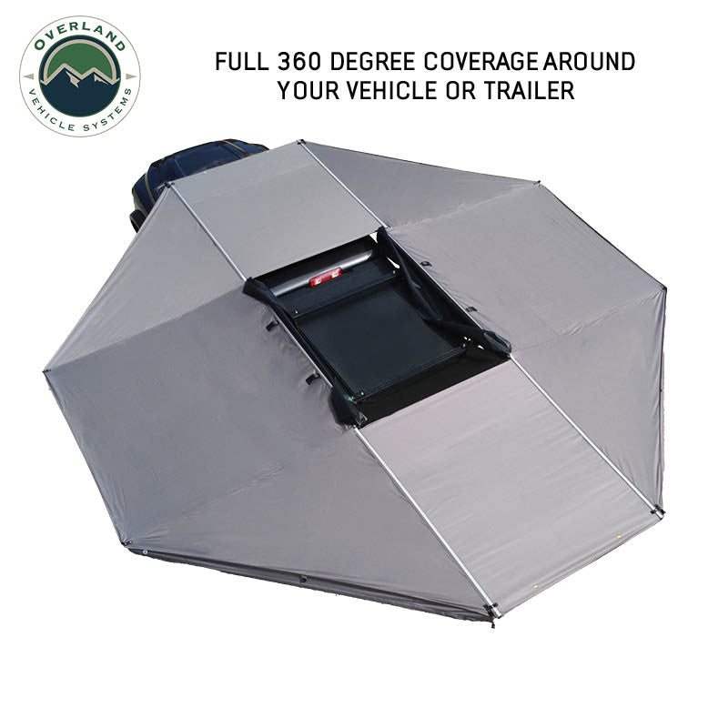 Image of OVS HD Nomadic 180 awning connector kit forming full 360-degree coverage around a vehicle, light gray fabric panels shown from an angled top-down view on a white background.