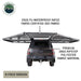 Image of OVS HD Nomadic 180 awning connector kit 6-piece version installed on a pickup truck, showing extended light gray ripstop fabric coverage with material callouts, rear view on a white background.