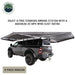 Image of OVS HD Nomadic 180 awning connector kit 2-piece version installed on a pickup truck, showing extended light gray awning coverage in a freestanding setup, angled rear side view on a white background.