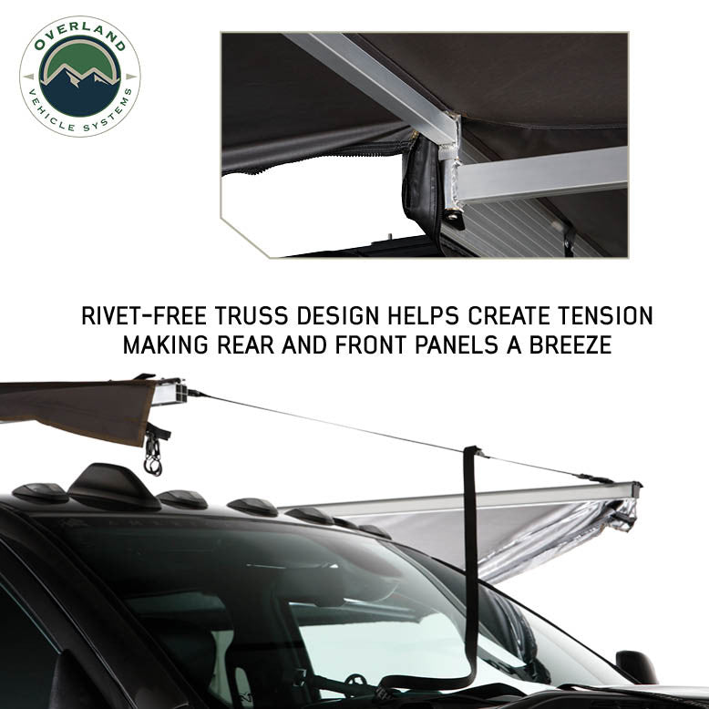 Image of OVS HD Nomadic 180 awning connector kit detail showing rivet-free truss support and tensioned front panel over a vehicle roof, light gray fabric in an angled side view on a white background.