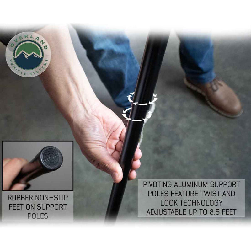 Image of a person's hand adjusting a black pivoting aluminum support pole for an Overland Vehicle Systems awning, highlighting the twist and lock technology. An inset shows a close-up of the pole's rubber non-slip foot