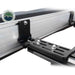 Image of a close-up of the black mounting bracket for an Overland Vehicle Systems 270-degree awning. The aluminum awning casing is shown attached to a roof rack, highlighting the heavy-duty bracket with its multiple adjustment slots and bolts