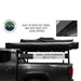 Image of an Overland Vehicle Systems 270-degree awning in its black 1000G PVC travel bag with heavy-duty zippers, mounted to a roof rack on a grey pickup truck. The travel cover dimensions are highlighted as 88" x 7" x 6"