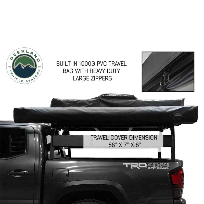 Image of an Overland Vehicle Systems 270-degree awning in its black 1000G PVC travel bag with heavy-duty zippers, mounted to a roof rack on a grey pickup truck. The travel cover dimensions are highlighted as 88" x 7" x 6"