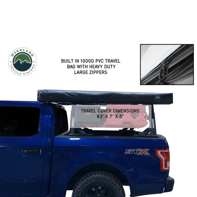 Image of a gray Nomadic 270 awning fully deployed to the side and rear of a vehicle, providing a large shaded area, from an overhead view on a white background