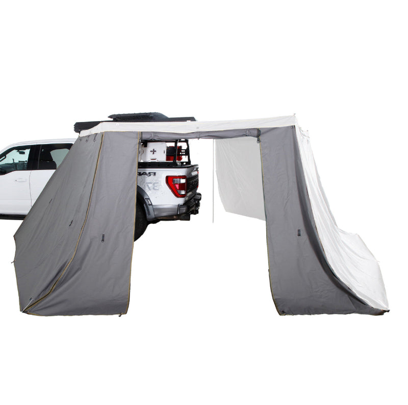 Image of a black vehicle awning packed in its 1000G PVC travel bag with heavy-duty zippers, mounted on a dark pickup truck's bed rack. The travel cover dimensions are displayed as 88" x 7" x 6"