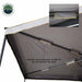 Image of a roof-mounted awning underside showing gray fabric canopy with support poles neatly stored using Velcro straps along the arms, angled underside detail view on white background.