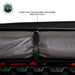 Image of a roof-mounted awning in stored position showing gray fabric securely rolled and held with heavy-duty Velcro storage straps, close-up exterior view on white background.
