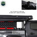 Image of a roof-mounted awning in closed position showing black built-in travel bag with heavy-duty zippers installed on a pickup truck rack, side profile view on white background.