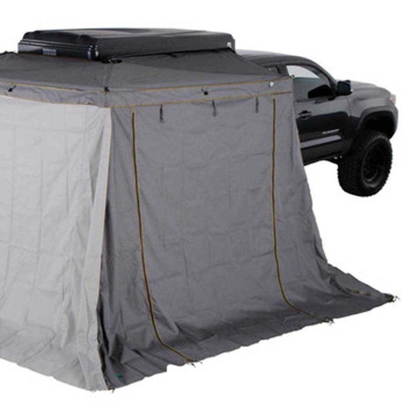Image of a gray pickup truck with a large, fully enclosed gray awning attachment featuring a white side panel, creating an expanded shelter.